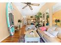Bright living area featuring a ceiling fan, hardwood floors, and stylish beach themed decor at 11511 113Th St # 35E, Largo, FL 33778