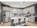 Modern kitchen features an island with white countertop and stainless steel appliances at 1182 25Th N Way, St Petersburg, FL 33713