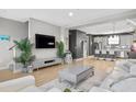 Spacious living room flows into the kitchen, complete with sleek furniture, hardwood floors, and modern decor, for easy living at 1182 25Th N Way, St Petersburg, FL 33713