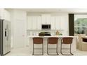 Bright, eat-in kitchen featuring modern stainless steel appliances, white cabinets, and counter seating at 11829 Sparkling Topaz Cv, Parrish, FL 34219