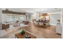 Spacious living area features wood floors, a dining area, and a seamless flow to the kitchen at 1218 Gillespie N Dr, Palm Harbor, FL 34684