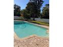 Private swimming pool with brick coping, perfect for relaxation and entertaining in a serene backyard setting at 13211 Park Blvd, Seminole, FL 33776