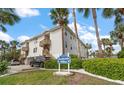 Beachside Villas with well-maintained landscaping, showcasing its proximity to the beach and inviting curb appeal at 1412 Gulf Blvd # 103A, Indian Rocks Beach, FL 33785