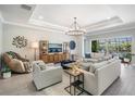 Bright living room featuring comfortable seating, stylish decor, and plenty of natural light at 16677 Vibrato Ln, Land O Lakes, FL 34638