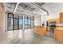 Bright living room featuring a large island, stainless appliances, and a view of the water at 175 2Nd S St # 907, St Petersburg, FL 33701
