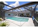 Screened-in pool area features a spacious deck, refreshing pool, and ample seating for outdoor relaxation at 1805 Stable Trl, Palm Harbor, FL 34685