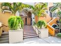 Inviting building entrance features tiled steps, lush greenery, and secure doorway at 200 4Th S Ave # 303, St Petersburg, FL 33701