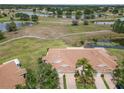 Serene aerial view of a residential community surrounded by lakes, golf courses, and lush green spaces at 2309 New Orchard Ct, Sun City Center, FL 33573