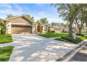 Inviting single-story home featuring a well-manicured lawn, two-car garage, and a long driveway at 3119 Bent Creek Dr, Valrico, FL 33596