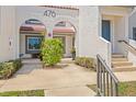 Inviting condo entrance featuring well-maintained landscaping, classic architectural details, and ample lighting at 476 Santa Cruz Ne Pl # C, St Petersburg, FL 33703