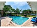 Inviting in-ground pool surrounded by lush landscaping and patio, perfect for outdoor relaxation and entertainment at 500 Tallahassee Ne Dr, St Petersburg, FL 33702