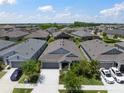 Beautiful single Gathering home with a well manicured lawn in an attractive neighborhood with a blue sky at 5609 Silver Sun Dr, Apollo Beach, FL 33572