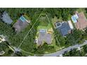 Aerial view of property showcasing lush greenery, sparkling pool, and surrounding neighborhood at 5902 Audubon Manor Blvd, Lithia, FL 33547