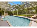 Relaxing screened-in pool area with clear water and comfortable seating perfect for entertaining at 5902 Audubon Manor Blvd, Lithia, FL 33547