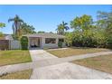 Charming single-story home with a well-maintained lawn, carport, and mature landscaping at 628 Bosphorous Ave, Tampa, FL 33606