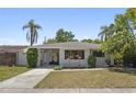 Delightful single-Gathering home with a convenient carport, lush lawn, and inviting curb appeal at 628 Bosphorous Ave, Tampa, FL 33606