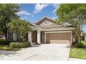 Inviting home exterior features a two-car garage and beautifully landscaped front yard at 6524 Park Strand Dr, Apollo Beach, FL 33572