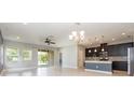 Bright and airy living area flows into the kitchen, featuring sliding glass doors at 6524 Park Strand Dr, Apollo Beach, FL 33572