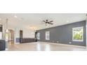 Open living space with tile flooring, ceiling fan, and natural light from multiple windows at 6524 Park Strand Dr, Apollo Beach, FL 33572