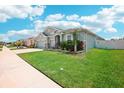 A lush lawn frames a well-maintained home exterior at 7323 Steer Blade Dr, Zephyrhills, FL 33541