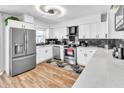 Modern kitchen with stainless steel appliances, white cabinets, and stylish countertops for a sleek design at 7530 85Th Ln, Seminole, FL 33777