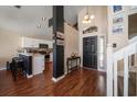 Inviting entryway open to the kitchen, wood floors, staircase, and black front door at 8103 Tar Hollow Dr, Gibsonton, FL 33534