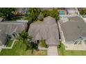 Overhead view of the single-Gathering home with a well maintained roof and lawn at 9327 Pontiac Dr, Tampa, FL 33626