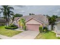 Beautiful single-story house with a two-car garage and well-maintained lawn at 9327 Pontiac Dr, Tampa, FL 33626