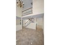 Open-concept living area with high ceilings, staircase, and lots of natural light at 962 Marco Ne Dr, St Petersburg, FL 33702
