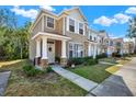 Attractive townhome with a well-manicured lawn, a covered porch, and a welcoming facade at 11041 Black Swan Ct, Seffner, FL 33584