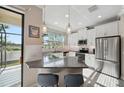 Modern kitchen with granite counters, stainless steel appliances, and a breakfast bar at 11548 Crowned Sparrow Ln, Tampa, FL 33626