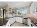 Bright kitchen showcasing granite countertops, subway tile backsplash, and stainless steel appliances at 11548 Crowned Sparrow Ln, Tampa, FL 33626