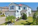 Beautiful two-story home with a well-manicured lawn, vibrant plants, and an inviting facade at 11625 Tetrafin Dr, Riverview, FL 33579