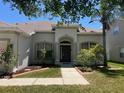 Inviting front entrance with well-maintained landscaping and a charming walkway at 11716 Summer Springs Dr, Riverview, FL 33579