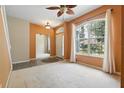 Inviting living room featuring a large window, ceiling fan, and neutral carpet at 11716 Summer Springs Dr, Riverview, FL 33579