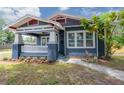 Charming craftsman home featuring a lovely front porch and manicured landscaping at 121 W Mohawk Ave, Tampa, FL 33604