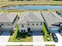 Aerial view of the home showcases its location near a pond and well-maintained landscaping at 14623 Horse Trot Rd, Lithia, FL 33547