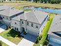 The aerial view shows the house surrounded by lush green landscaping and nearby community amenities at 14623 Horse Trot Rd, Lithia, FL 33547