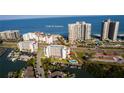 Beautiful aerial view of waterfront condos, a boat dock, pool, and beach access on Sand Key near the Gulf of America at 1581 Gulf Blvd # 301N, Clearwater Beach, FL 33767