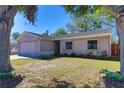 Charming single-story home with a well-maintained lawn and mature trees, providing a welcoming curb appeal at 1915 Peppertree Dr, Oldsmar, FL 34677