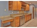 Spacious kitchen featuring granite countertops, stainless steel appliances, and plenty of cabinet space with a wine rack at 1915 Peppertree Dr, Oldsmar, FL 34677