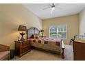 Comfortable bedroom with a ceiling fan, a large window, and neutral decor at 20117 Indian Rosewood Dr, Tampa, FL 33647