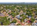 Expansive aerial view showcasing neighborhood, lush trees, and downtown cityscape in the distance at 2050 28Th N Ave, St Petersburg, FL 33713