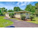 Charming single-story brick home features well-maintained landscaping and a welcoming walkway at 2054 Deerwood Rd, Seffner, FL 33584