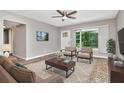 Bright living room with a large window, a ceiling fan, stylish furniture and contemporary decor at 2054 Deerwood Rd, Seffner, FL 33584