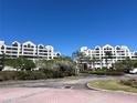 Exterior shot of the condominium buildings in a beautifully landscaped and well-maintained community on a sunny day at 2333 Feather Sound Dr # B104, Clearwater, FL 33762