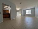 Living room with neutral paint, tile floor, a dining area, access to the kitchen, and a sliding door to the outside balcony at 2333 Feather Sound Dr # B104, Clearwater, FL 33762
