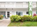 Close-up view of the condo's exterior entrance with well-manicured landscaping and clearly marked unit numbers at 2469 Franciscan Dr # 19, Clearwater, FL 33763