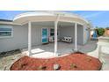 Inviting front porch with cozy seating and landscaping provides a relaxing space to enjoy the outdoors at 3422 Trask Dr, Holiday, FL 34691