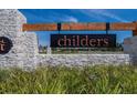 Elegant stone entrance to the Childers community with a wood and metal sign at 34780 Rainville Loop, Zephyrhills, FL 33541